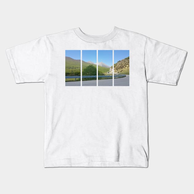 A static shot from the panoramic point Castaldia di Piancavallo; road to the tunnel inside the hill. Beautiful nature in a spring sunny day; no people around Kids T-Shirt by fabbroni-art